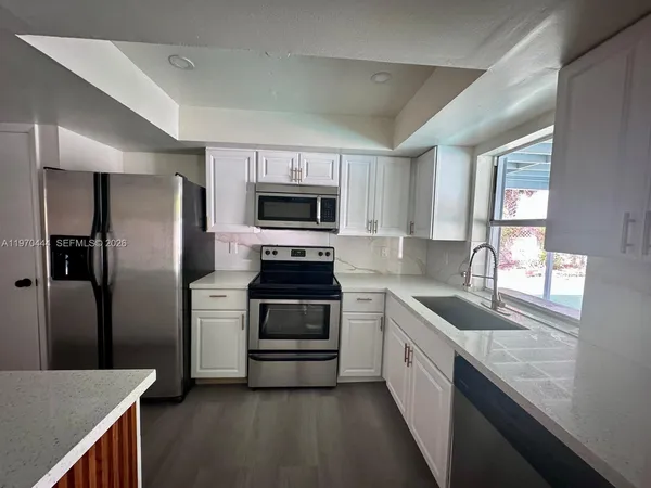 a kitchen with a sink stove and refrigerator