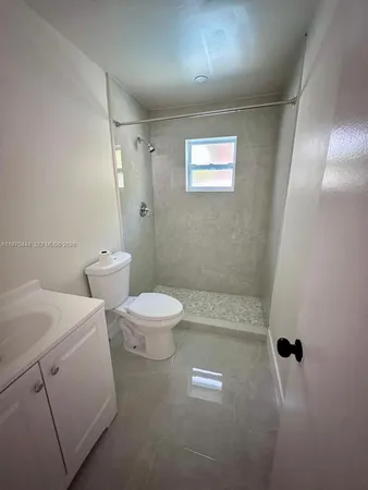 a bathroom with a toilet sink and shower