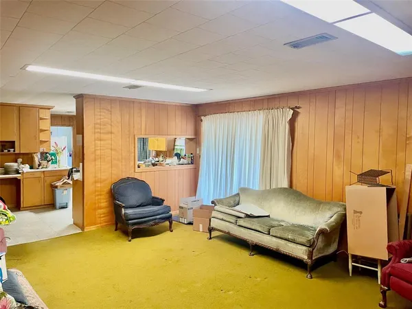 a living room with furniture pool table and a couch