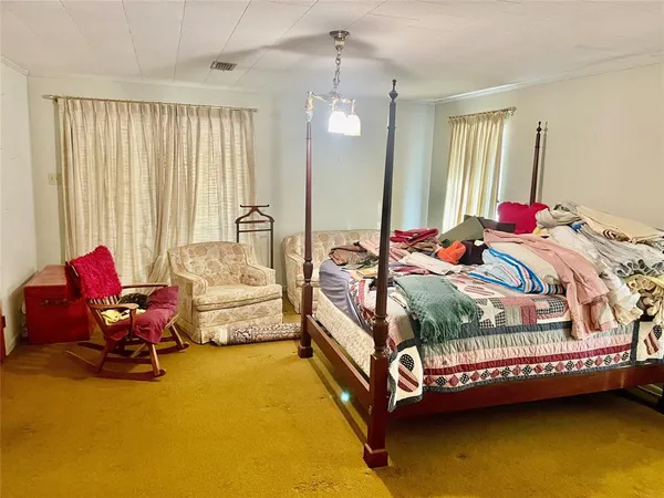 a bedroom with bed and window