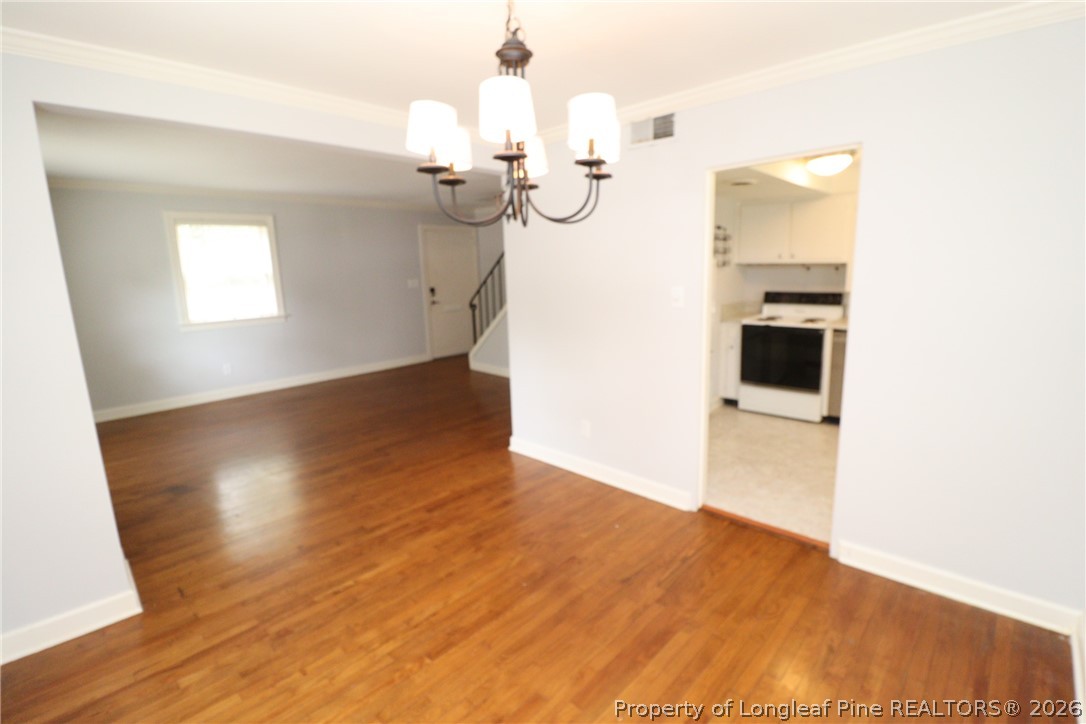 1000 Nichols Drive Raleigh, NC 27605 - Photo 6 of 22 a view of a room with wooden floor staircase and kitchen view
