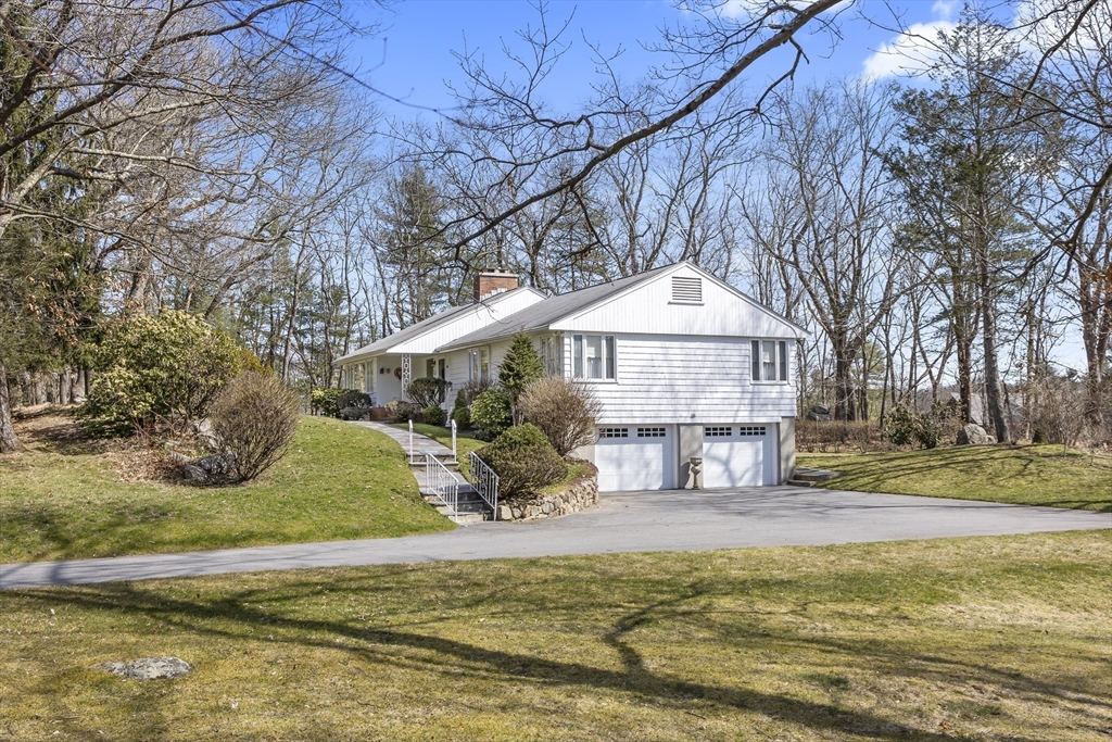 4 Deerhaven Road Lincoln, MA 01773 - Photo 33 of 41 a view of a house with a yard patio and fire pit