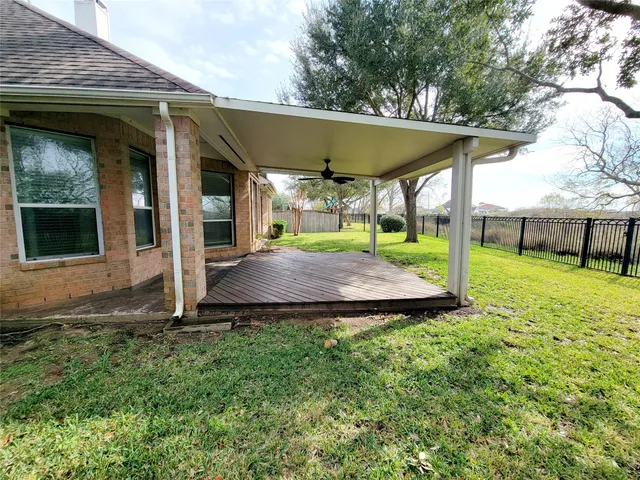 a view of a house with backyard and porch