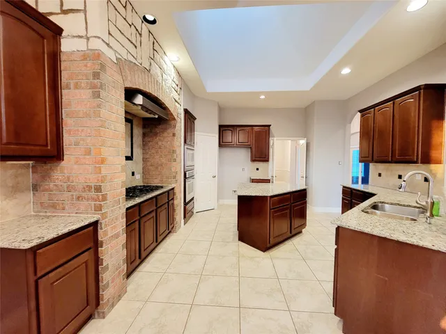 a large kitchen with stainless steel appliances and cabinets