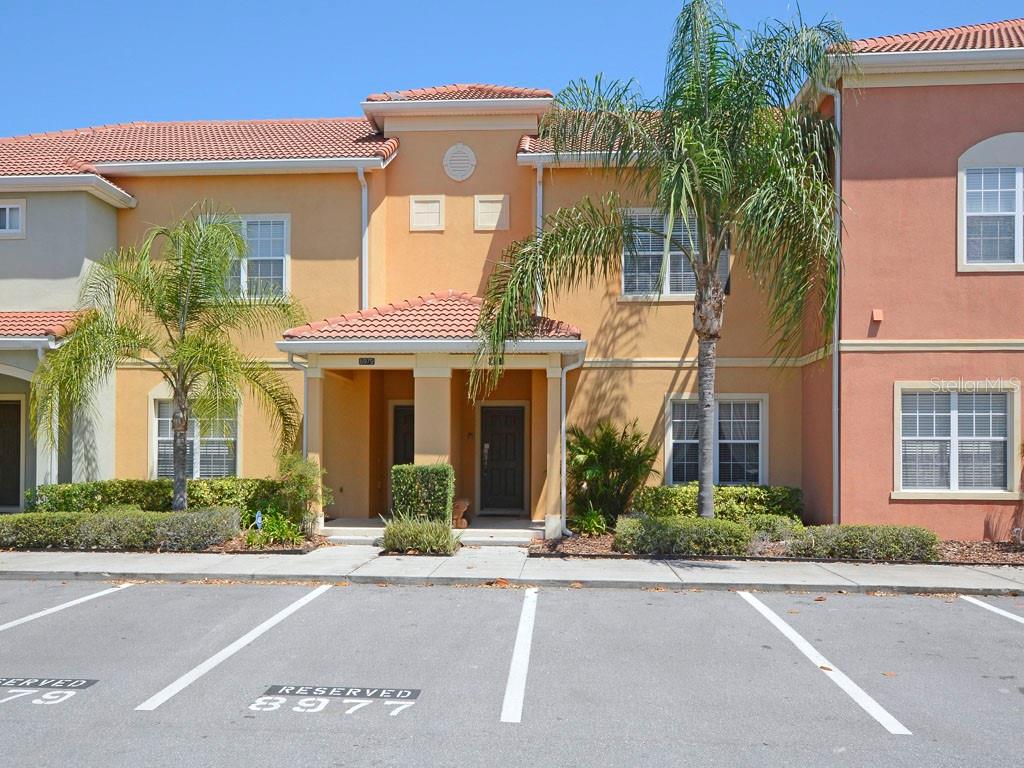 front view of a brick house with a yard