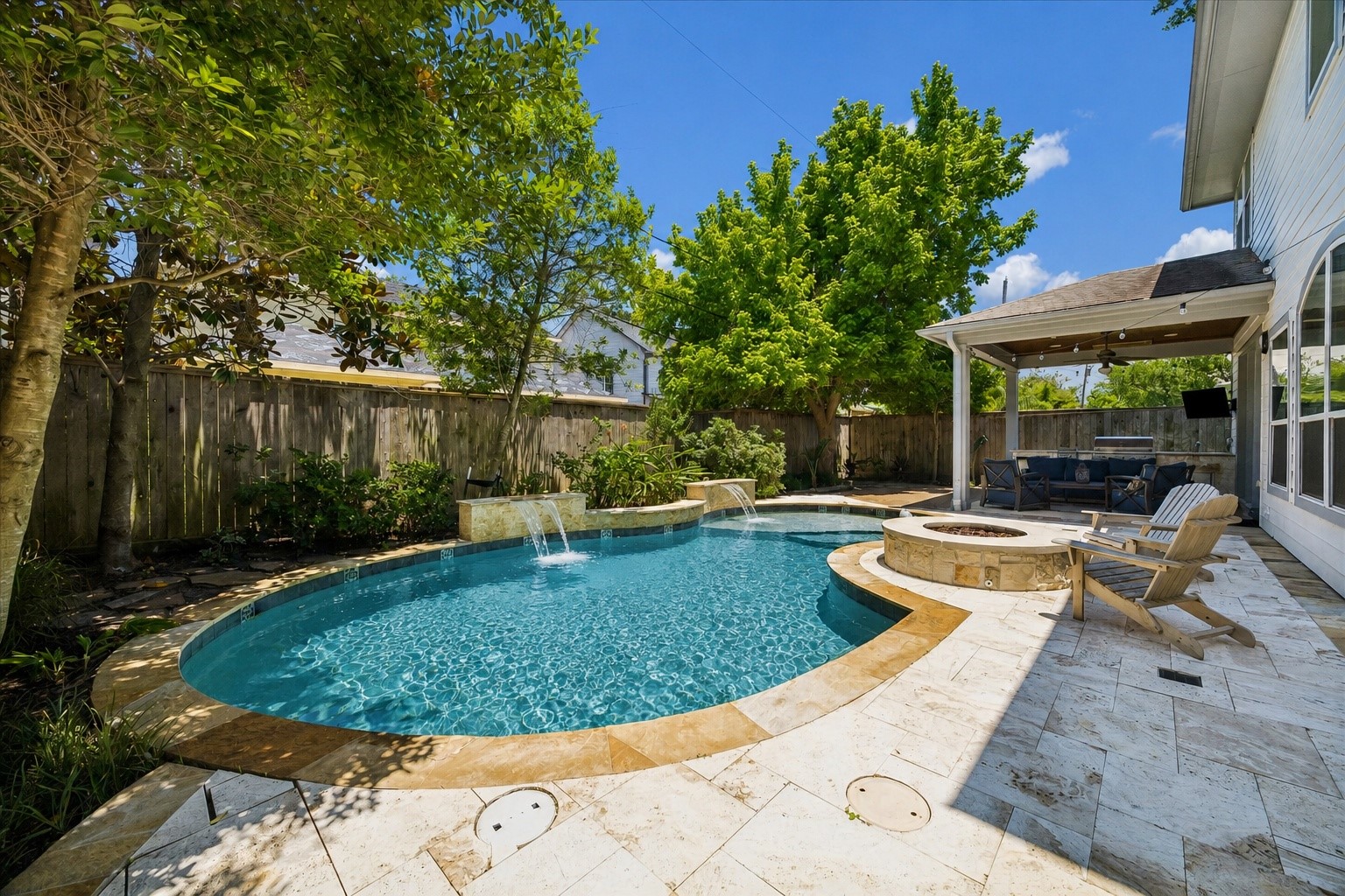 1360 Chippendale Road Houston, TX 77018 - Photo 27 of 34 Beautiful view back toward the home showcasing the covered patio, summer kitchen, sparkling pool, and seamless indoor-outdoor living. Designed to maximize both functionality and enjoyment, this backyard serves as a true extension of the home's living spaces.