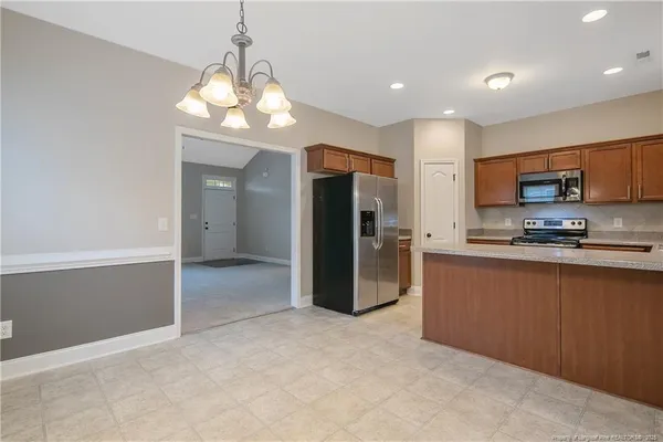 a kitchen with stainless steel appliances granite countertop a refrigerator and a sink