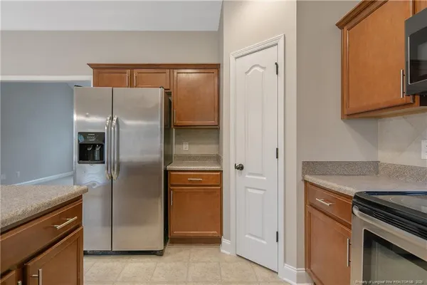 a kitchen with metallic refrigerator freezer and a dishwasher