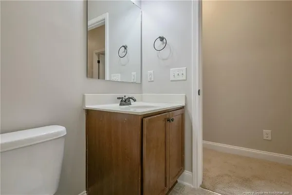 a bathroom with a sink a toilet and mirror
