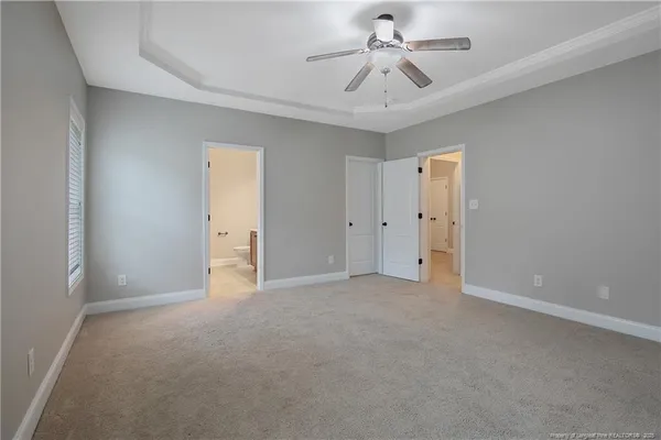 a view of empty room with ceiling fan
