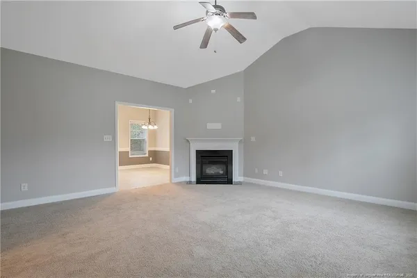 a view of empty room with a fireplace