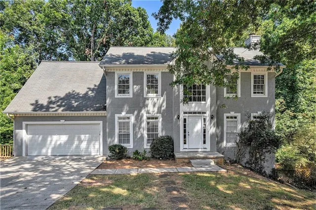a front view of a house with a garden
