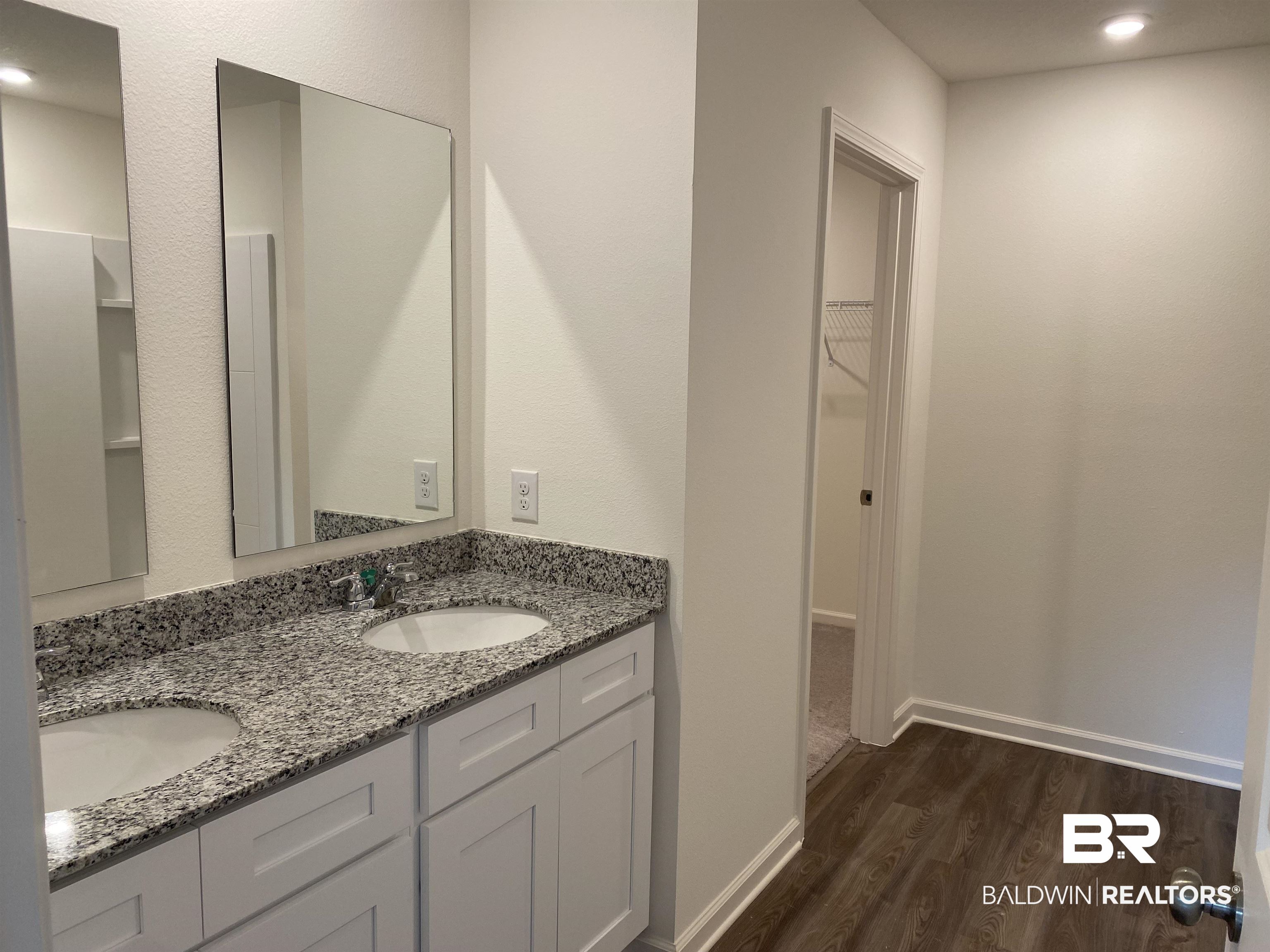 21676 Yosemite Boulevard Fairhope, AL 36532 - Photo 9 of 19 Bathroom with hardwood / wood-style floors and vanity