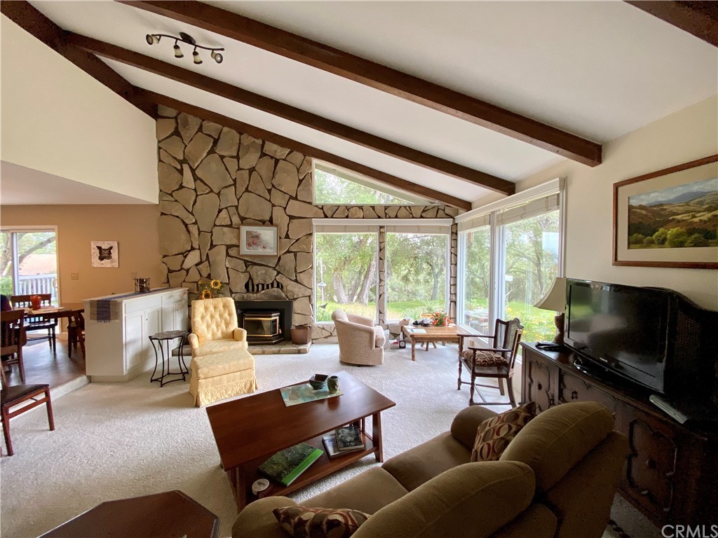 7605 San Gregorio Road Atascadero, CA 93422 - Photo 5 of 22 a living room with furniture a fireplace and a flat screen tv