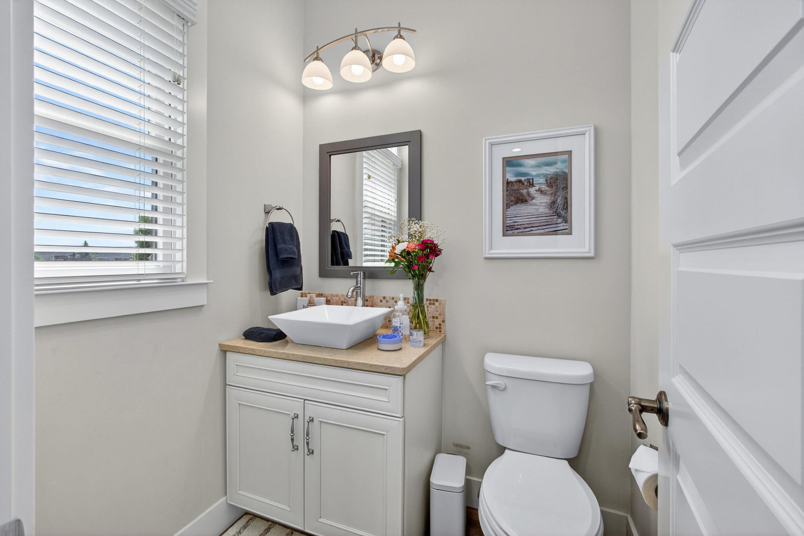 5700 Emily Road Bettendorf, IA 52722 - Photo 16 of 58 a bathroom with a toilet sink and mirror