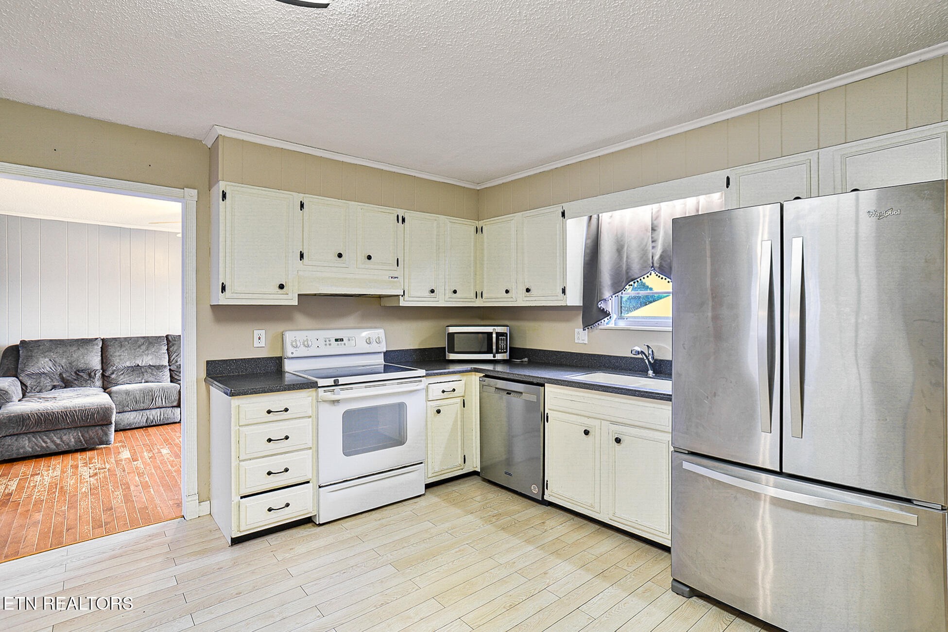 7701 Maida Vale Circle Powell, TN 37849 - Photo 12 of 36 a kitchen with stainless steel appliances granite countertop a refrigerator sink and stove