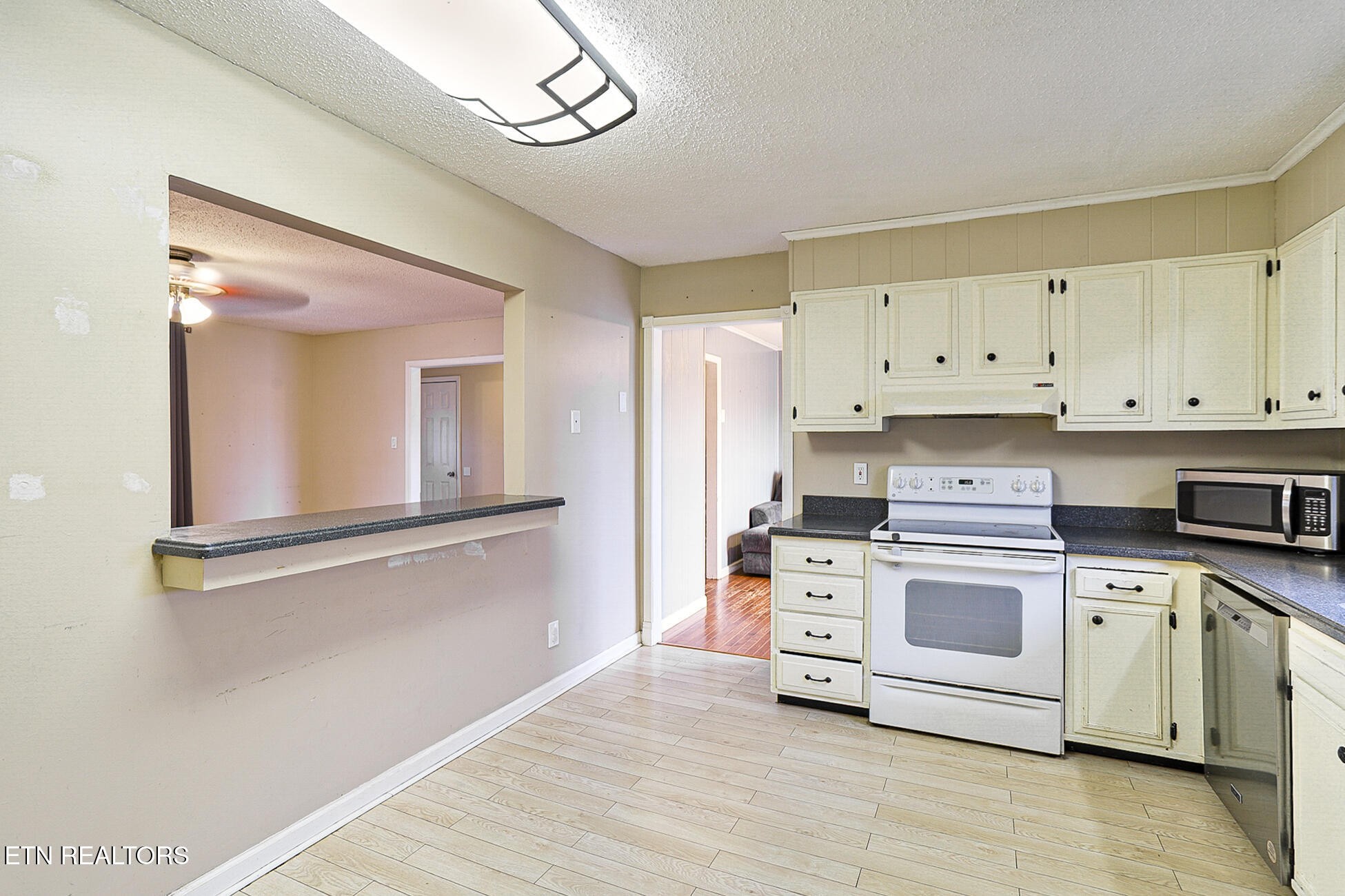 7701 Maida Vale Circle Powell, TN 37849 - Photo 13 of 36 a kitchen with cabinets stainless steel appliances and wooden floor