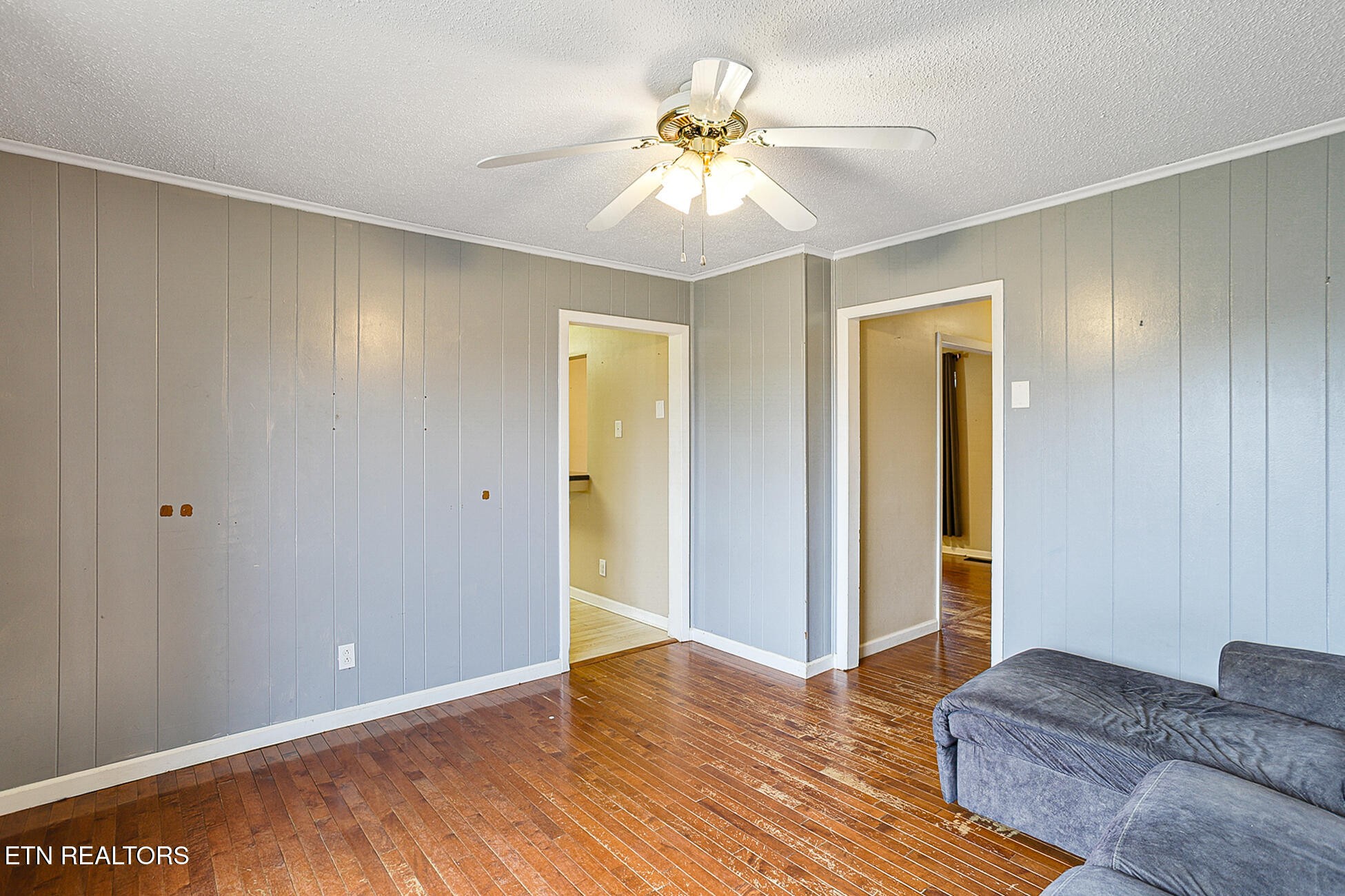 7701 Maida Vale Circle Powell, TN 37849 - Photo 8 of 36 a living room with a bed and a chandelier