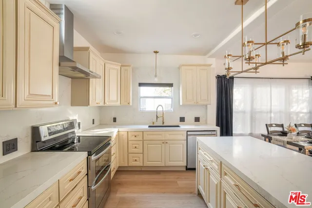 a very nice looking dining room with kitchen island furniture and a chandelier