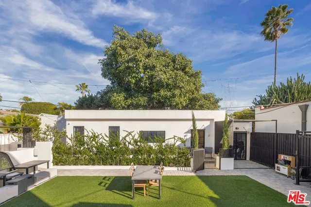 a view of a patio with table and chairs and potted plants
