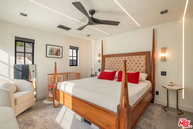 a bedroom with a bed and a large window