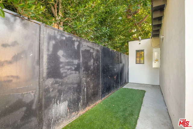 a view of an entrance to house with yard