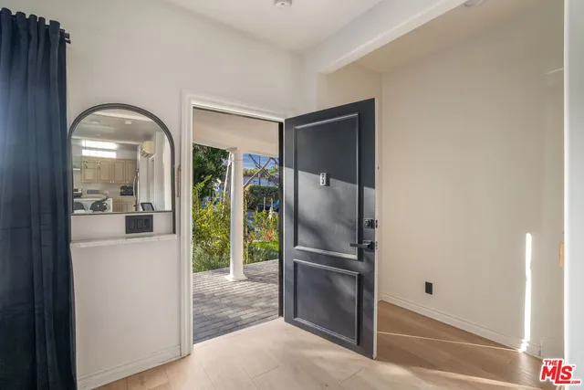 a living room with furniture and a view of kitchen