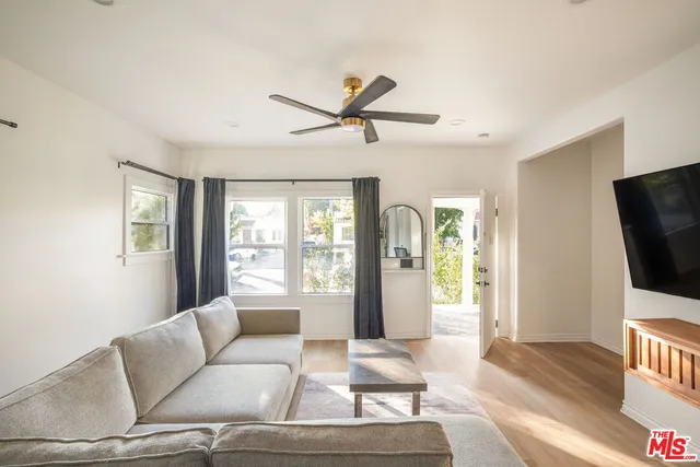 a dining room with furniture a window and a kitchen view