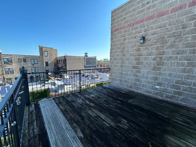 a view of a balcony with wooden floor