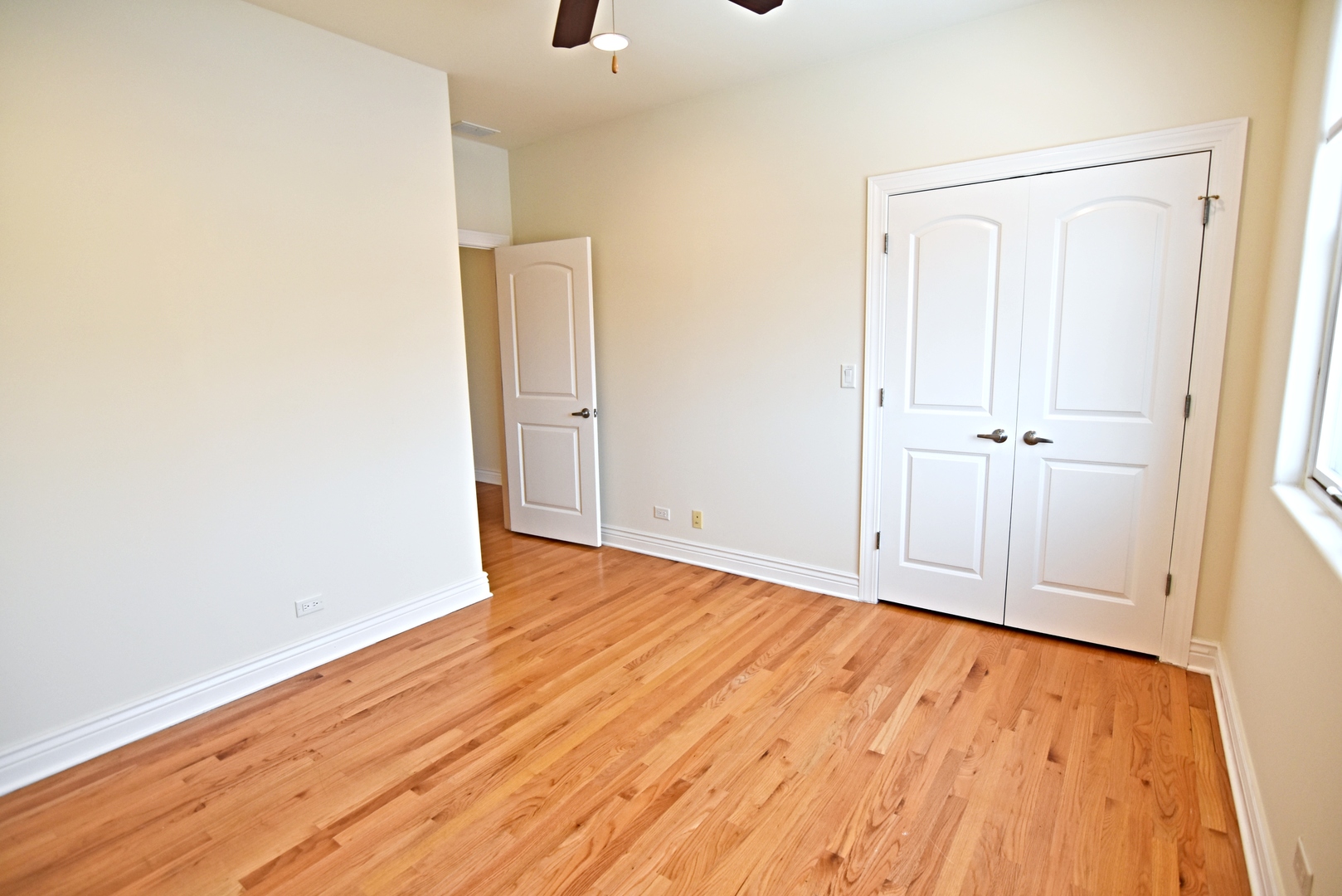 5140 North Clark Street Chicago, IL 60640 - Photo 4 of 14 a view of an empty room with wooden floor