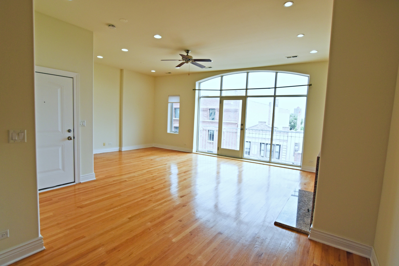 5140 North Clark Street Chicago, IL 60640 - Photo 7 of 14 a view of an empty room with wooden floor and a window