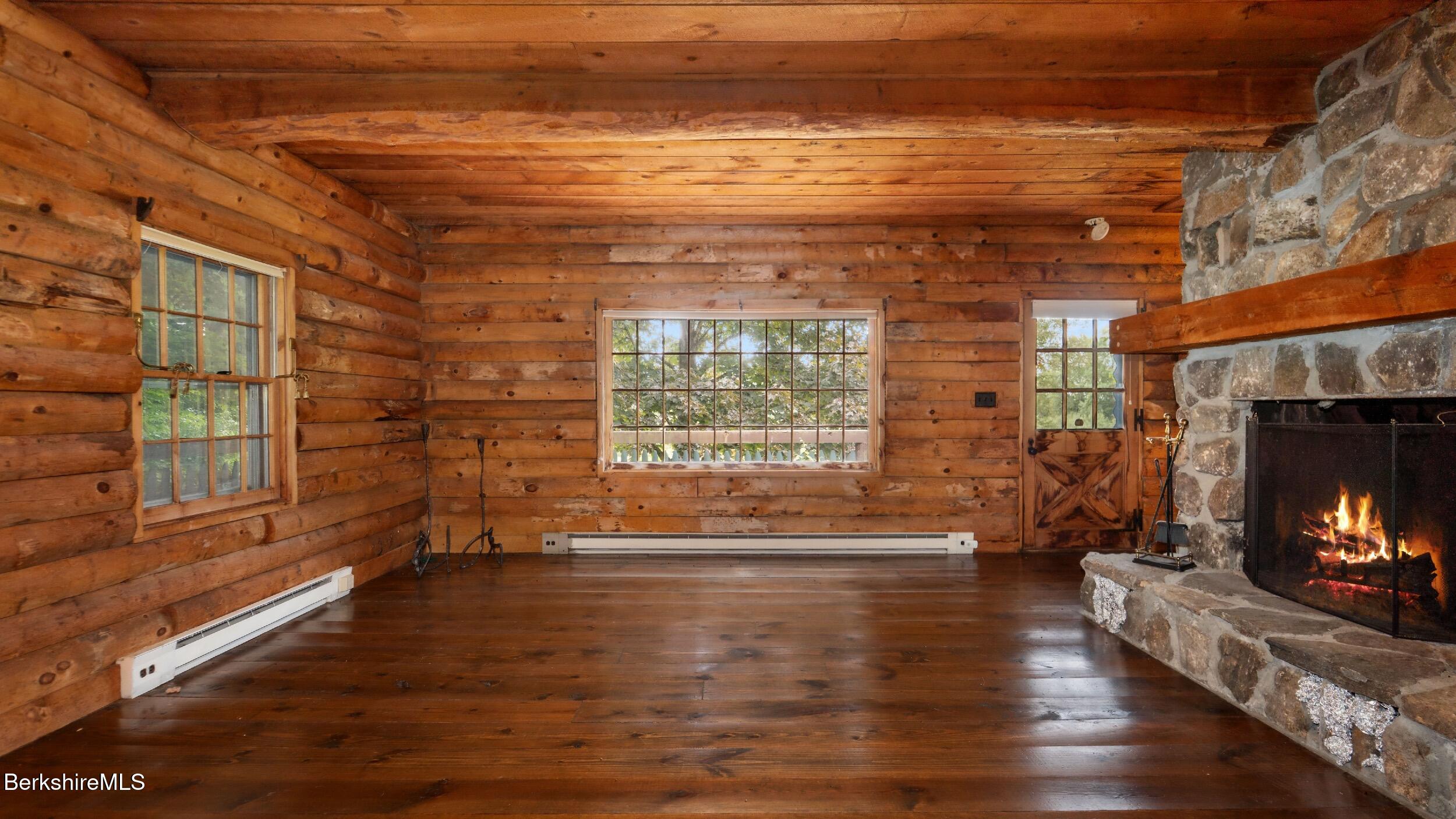 76 Corashire Road New Marlborough, MA 01230 - Photo 15 of 31 a view of empty room with wooden floor and fireplace