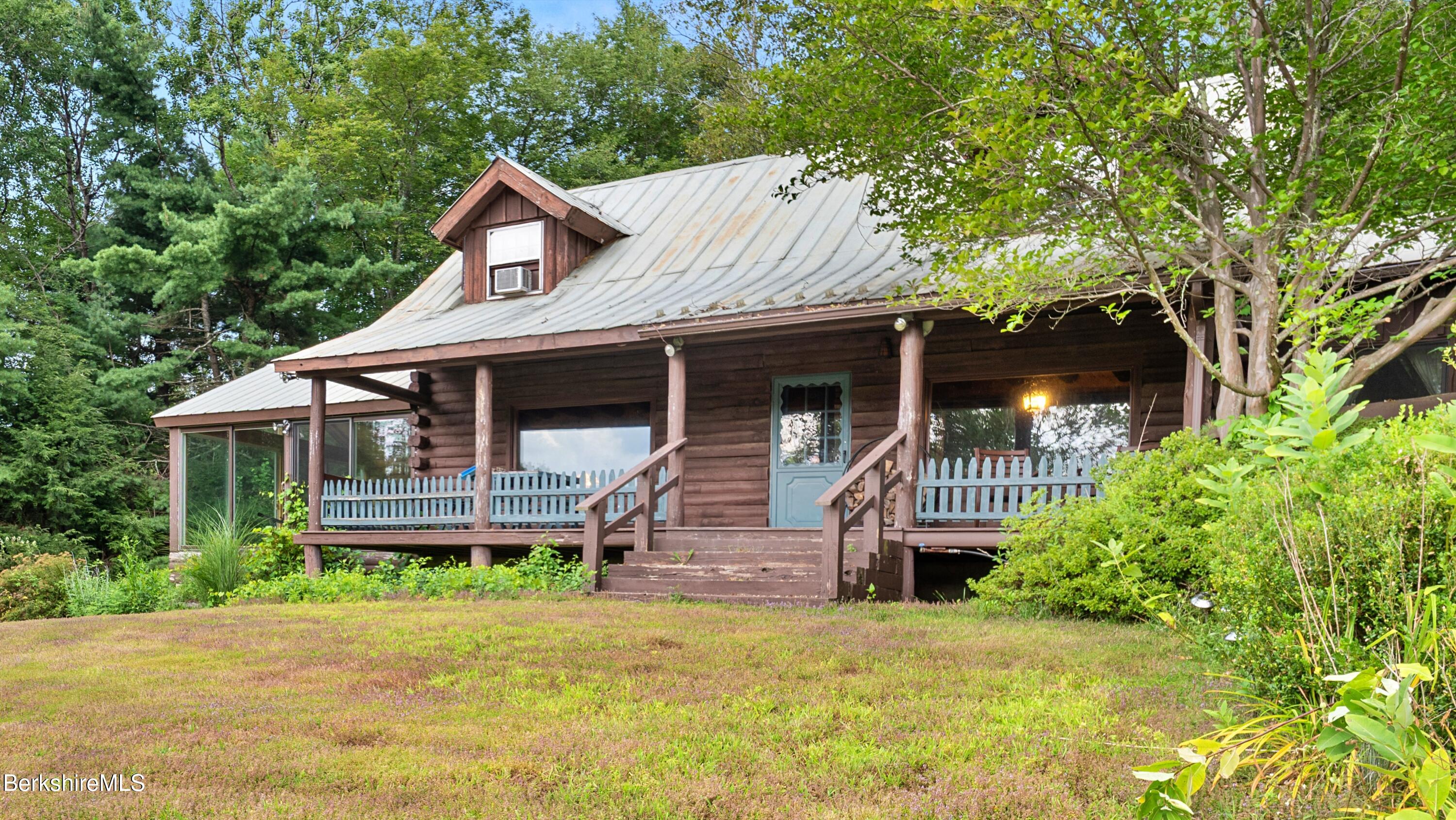76 Corashire Road New Marlborough, MA 01230 - Photo 29 of 31 a front view of a house with a yard balcony and trees