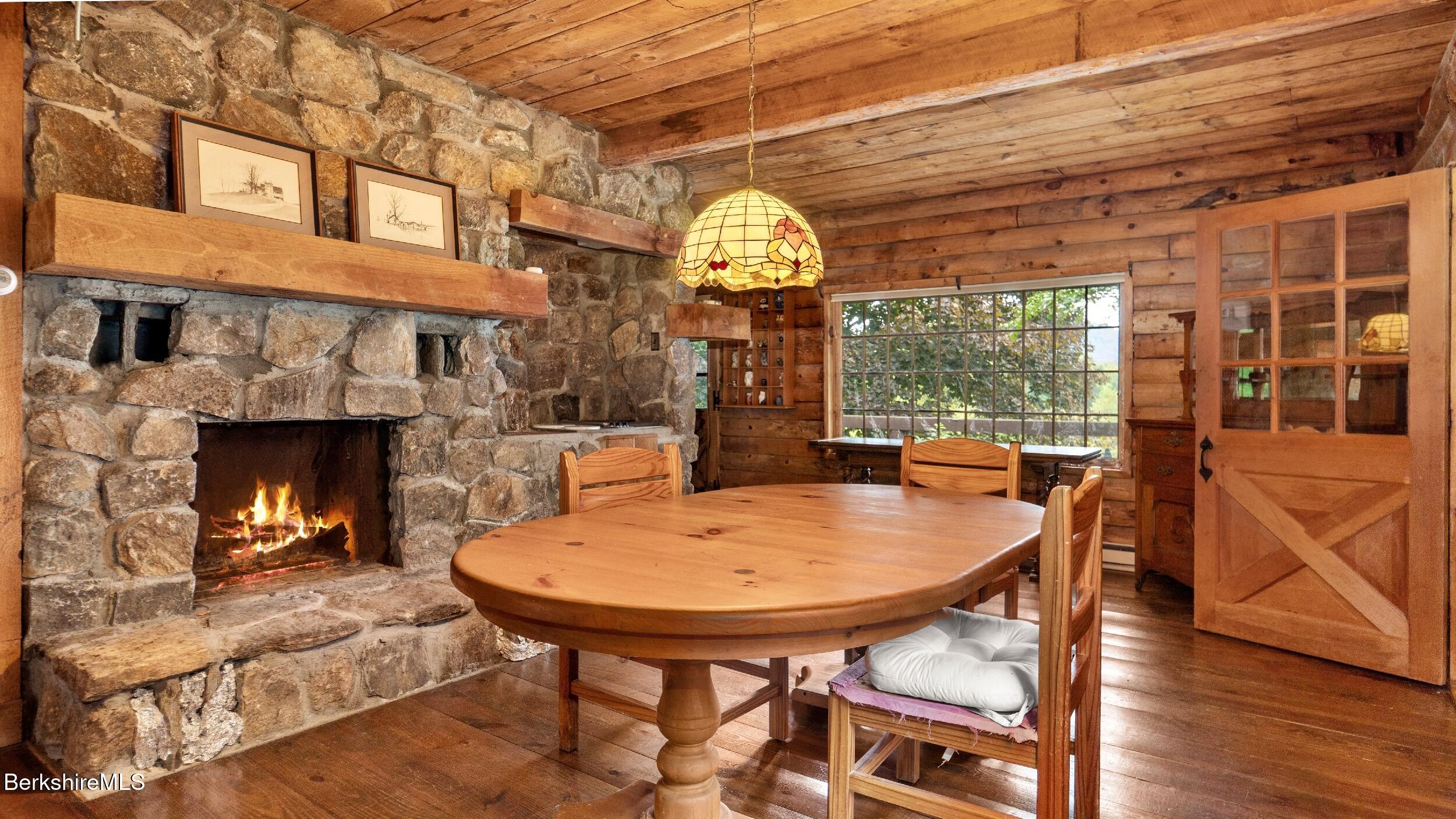 76 Corashire Road New Marlborough, MA 01230 - Photo 8 of 31 a dining room with furniture a fireplace and a large window