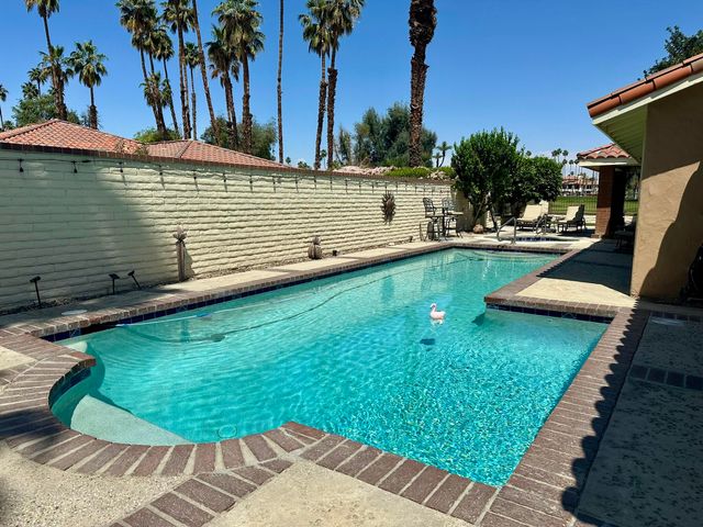 a view of a swimming pool with a patio