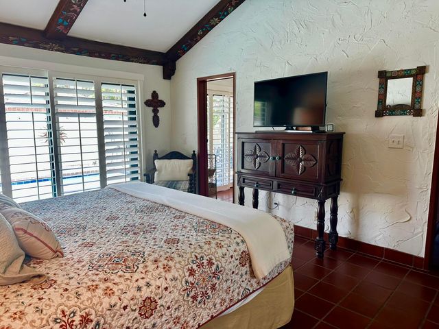 a bedroom with a bed and a flat screen tv