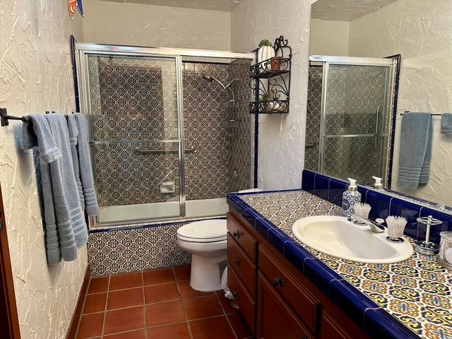 a bathroom with a sink toilet and shower