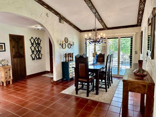 a view of a dining room with furniture and chandelier