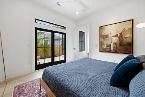 a bedroom with a bed and a painting on the wall
