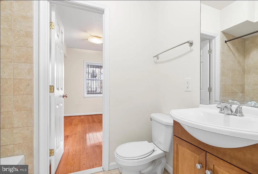 1401 Druid Hill Avenue, Unit B Baltimore, MD 21217 - Photo 12 of 23 a bathroom with a sink a toilet and shower