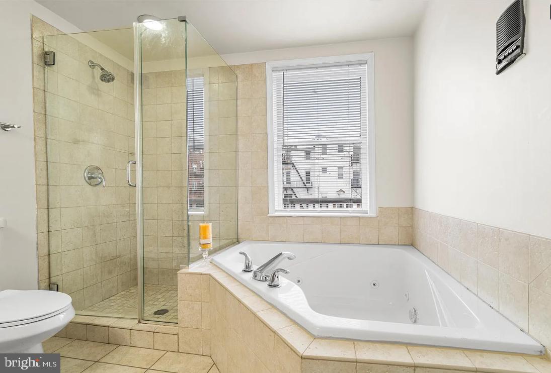 1401 Druid Hill Avenue, Unit B Baltimore, MD 21217 - Photo 21 of 23 a bathroom with a tub a toilet and a shower