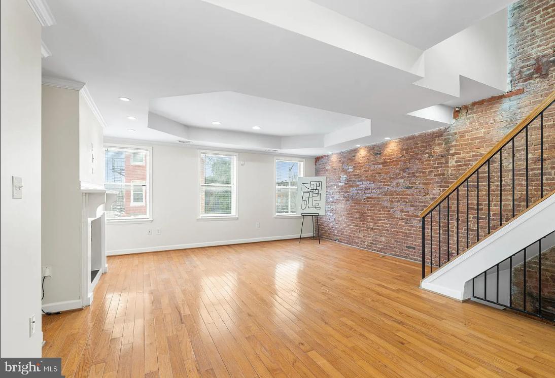 1401 Druid Hill Avenue, Unit B Baltimore, MD 21217 - Photo 6 of 23 a view of an empty room with wooden floor and a window