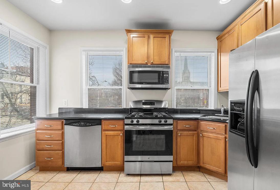 1401 Druid Hill Avenue, Unit B Baltimore, MD 21217 - Photo 8 of 23 a kitchen with granite countertop a stove sink and refrigerator