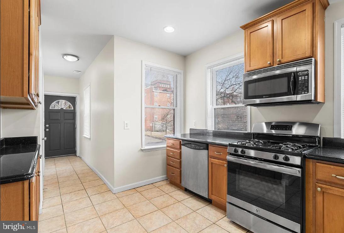 1401 Druid Hill Avenue, Unit B Baltimore, MD 21217 - Photo 9 of 23 a kitchen with granite countertop a stove top oven microwave and cabinets