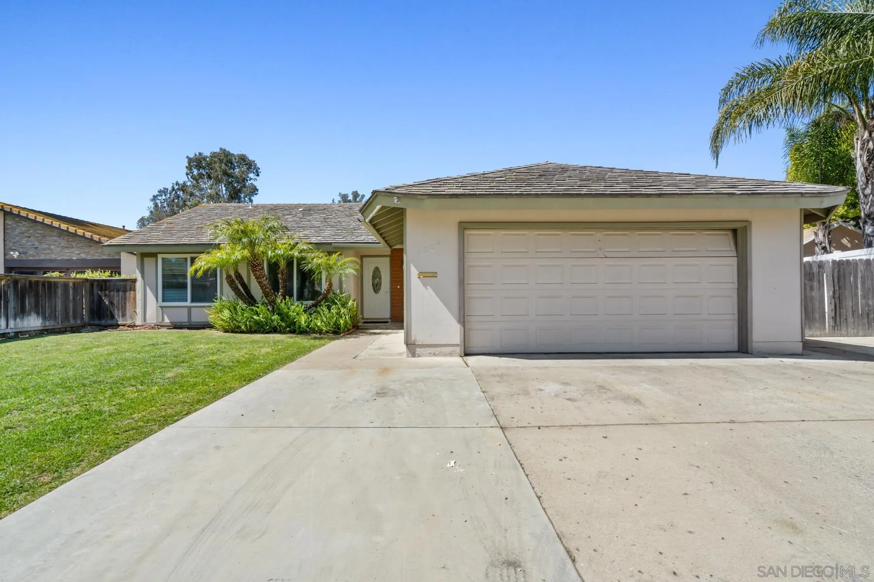13246 Powers Court Poway, CA 92064 - Photo 2 of 39 a front view of a house with a yard and garage