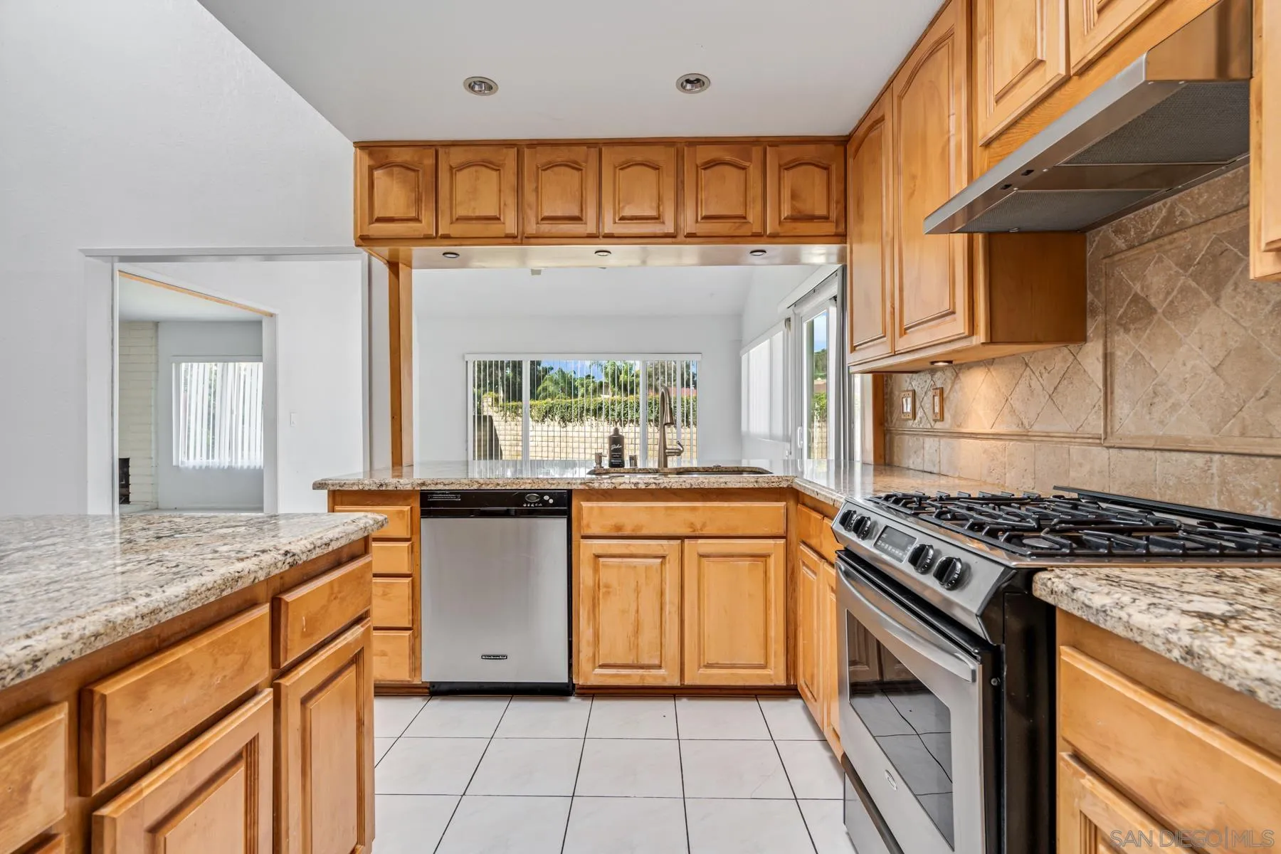 13246 Powers Court Poway, CA 92064 - Photo 6 of 39 a kitchen with stainless steel appliances granite countertop a stove a sink and a microwave