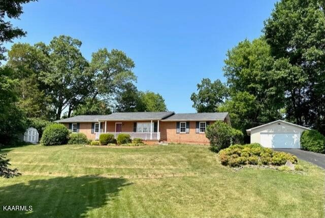 600 Schenley Road Knoxville, TN 37923 - Photo 1 of 38 a front view of a house with a yard table and chairs