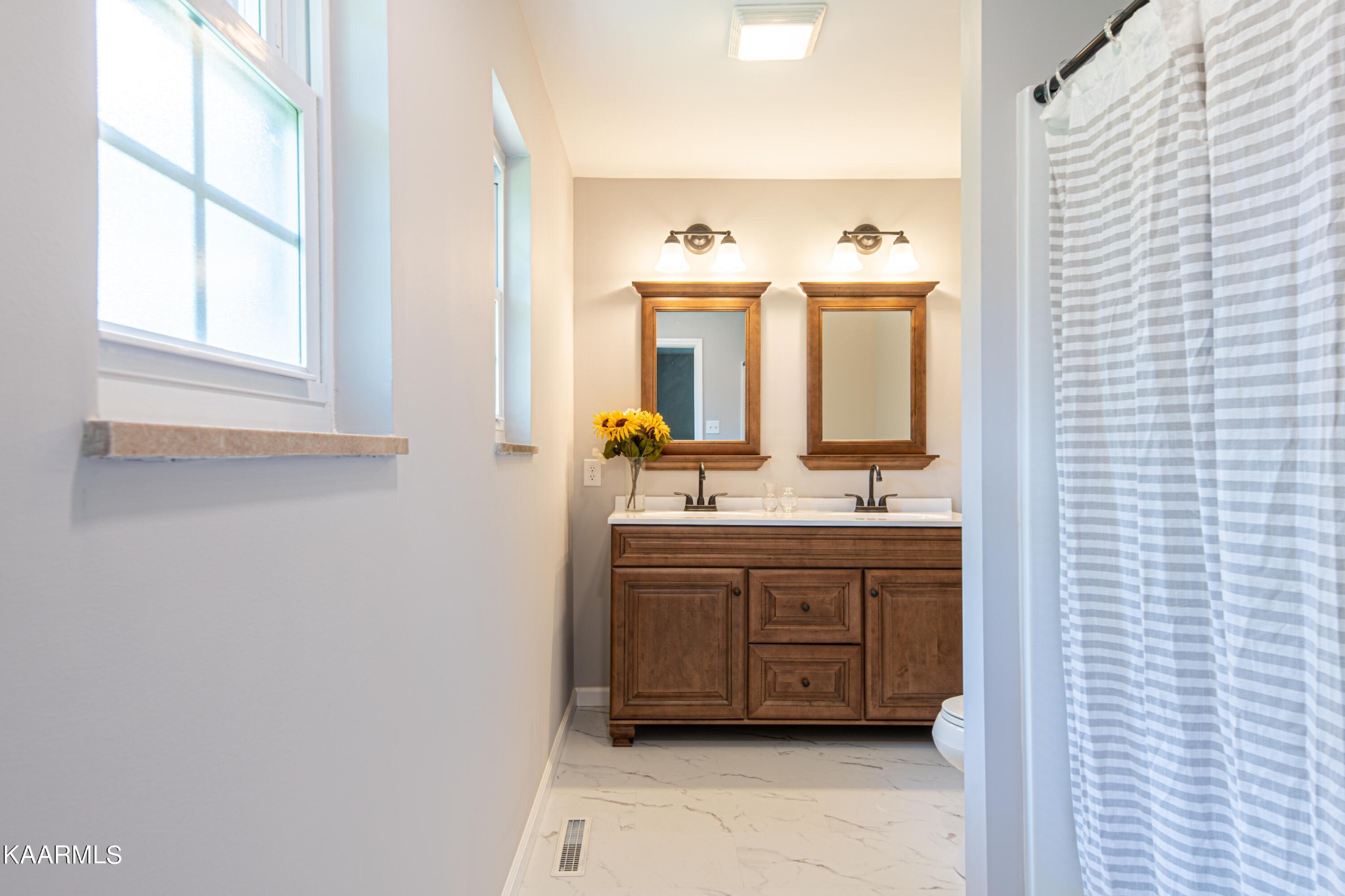 600 Schenley Road Knoxville, TN 37923 - Photo 18 of 38 a bathroom with a double vanity sink mirror and window