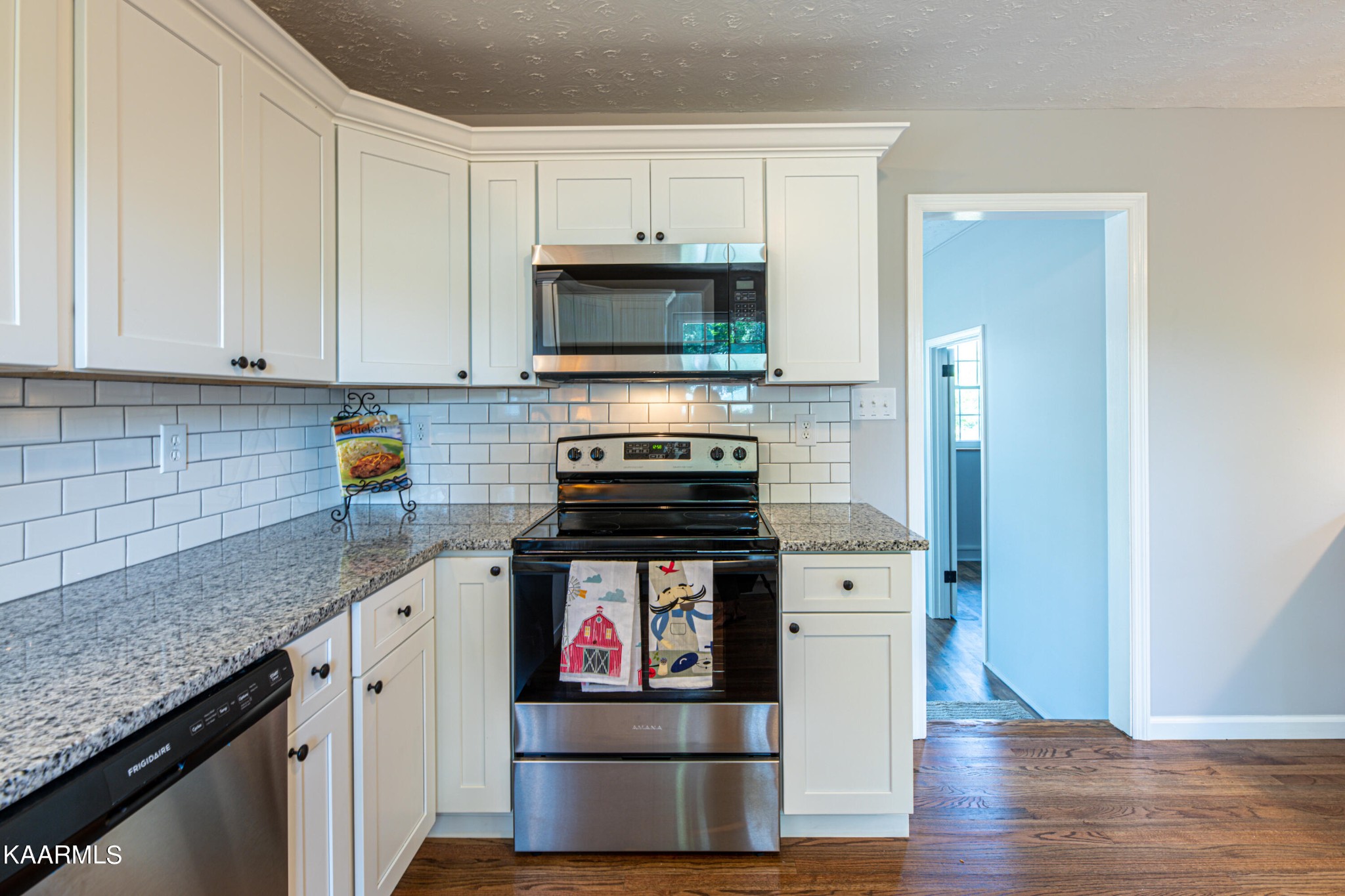 600 Schenley Road Knoxville, TN 37923 - Photo 9 of 38 a kitchen with stainless steel appliances granite countertop a stove and a wooden cabinets