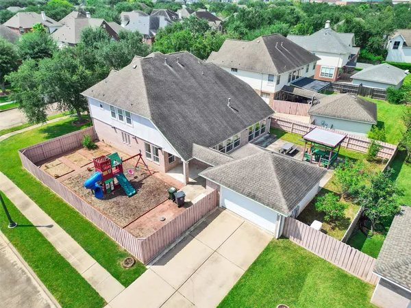 an aerial view of a house with garden space and street view